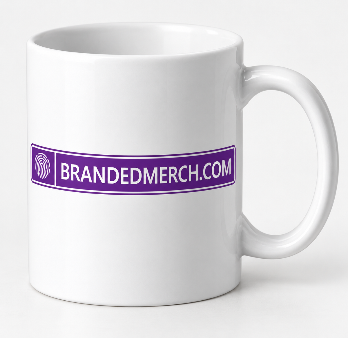 White 11oz ceramic mug with the BrandedMerch logo as a branding example